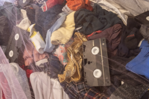 Closeup of clothing and a VHS tape in Adam Tendler's Exit Strategy